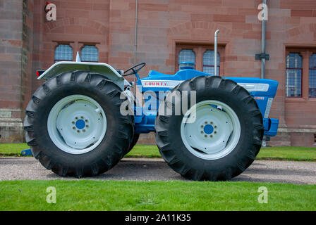 Immaculate 1966 Blue White Ford County Super 6 1004 Model Tractor Isle of Bute Scotland United Kingdom drivers right hand side offside view old gleami Stock Photo