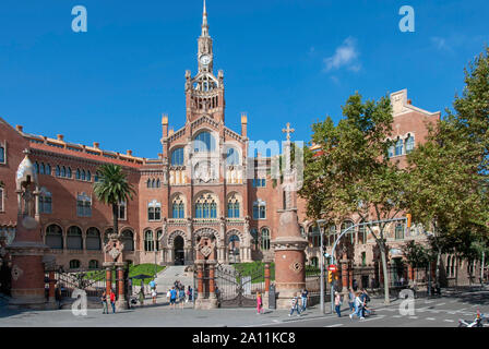 The Former Hospital of the Holy Cross and Saint Paul El Guinardo Barcelona Catalonia Spain exterior view of the gateway and central clock tower built Stock Photo