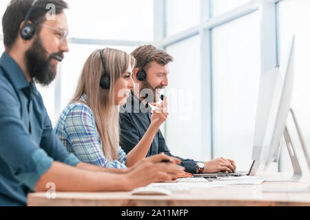 call center operators use computers to work with clients. Stock Photo