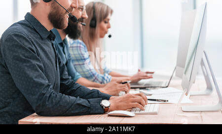 call center employees work on modern computers Stock Photo