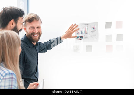 business team discusses financial schedules standing in the office Stock Photo