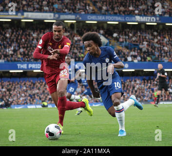 LONDON, ENGLAND - SEPTEMBER 22: Liverpool’s Joel Matip tackles Chelsea’s Willian during the Premier League match between Chelsea FC and Liverpool FC at Stamford Bridge on September 22, 2019 in London, United Kingdom. (Hugo Philpott/MB Media) Stock Photo