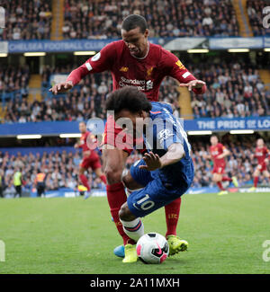 LONDON, ENGLAND - SEPTEMBER 22: Liverpool’s Joel Matip tackles Chelsea’s Willian during the Premier League match between Chelsea FC and Liverpool FC at Stamford Bridge on September 22, 2019 in London, United Kingdom. (Hugo Philpott/MB Media) Stock Photo