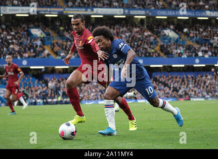 LONDON, ENGLAND - SEPTEMBER 22: Liverpool’s Joel Matip tackles Chelsea’s Willian during the Premier League match between Chelsea FC and Liverpool FC at Stamford Bridge on September 22, 2019 in London, United Kingdom. (Hugo Philpott/MB Media) Stock Photo