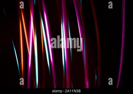 Multicoloured bright neon abstract for backgrounds Lights in motion on black background Stock Photo