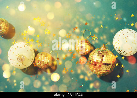 Christmas composition. Flat lay, top view. Disco ball bauble, star sparkles. Minimal New year party concept. Christmas white and gold decorations on g Stock Photo