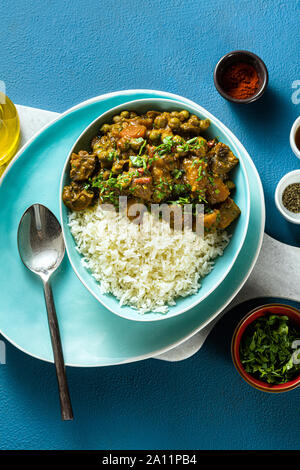 vegetable curry with pumpkin and mushrooms. with rice on the table. healthy indian food. shot from above. copy space Stock Photo
