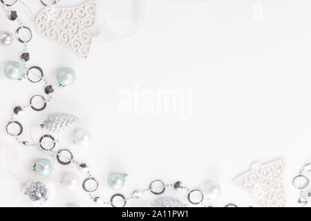 Christmas composition. Christmas white and silver decorations, on white background. Flat lay, top view, copy space Stock Photo