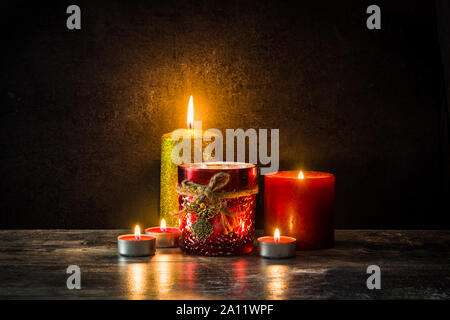 Christmas candles on wooden table and black background Stock Photo