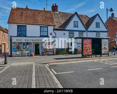 Outside view of B D Crayden newsagents and a bus stop nearby in the Broadway high street in Thatcham on a quiet summers day, Thatcham, Berkshire, UK Stock Photo
