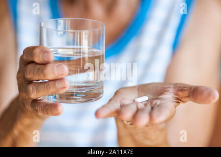 Senior woman taking her daily prescribed medication Stock Photo