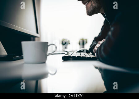Computer hacker stealing valuable information from web Stock Photo