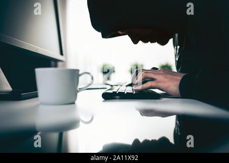 Computer hacker stealing valuable information from web Stock Photo