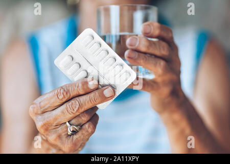 Senior woman taking her daily prescribed medication Stock Photo