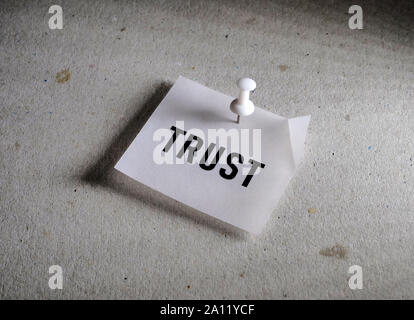 Close up of a trust word label on paper Stock Photo