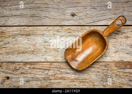 empty rustic wooden scoop against weathered barn wood Stock Photo