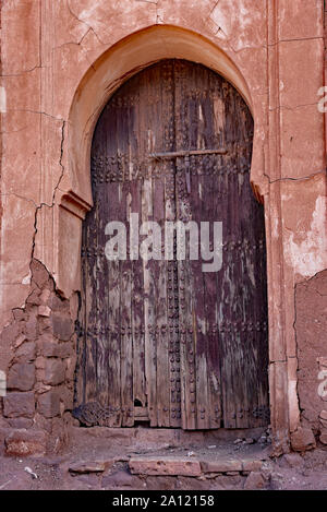 Distressed wooden door in the abandoned and partially ruined el-Glaoui Kasbah of Telouet, High Atlas region, Morocco, North Africa. Stock Photo