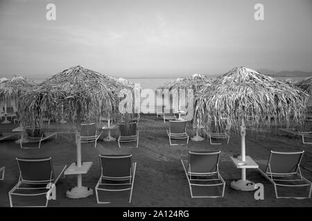 sun beds and beach umbrellas vouliagmeni athens attica greece Stock Photo