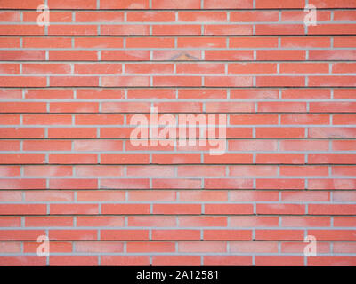 Wall made of red bricks and gray joints at day. Stock Photo