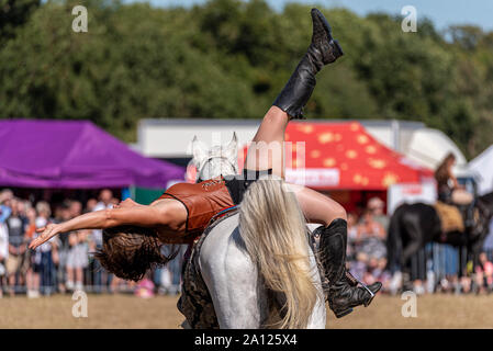 Equestrienne Stunt Shows horse display at the National Country Show Live at Hylands Park, Chelmsford, Essex, UK. Horse event team Stock Photo