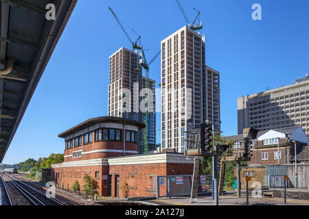 View of the new Victoria Square development over the old-fashioned red brick built signal box in the station at Woking, Surrey, south-east England, UK Stock Photo