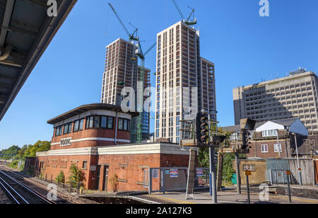 View of the new Victoria Square development over the old-fashioned red brick built signal box in the station at Woking, Surrey, south-east England, UK Stock Photo