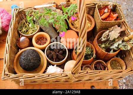 Various dried meadow herbs and herbal tea in the basket. Stock Photo