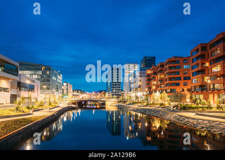 Oslo, Norway. Night View Embankment And Residential Multi-storey House In Gamle Oslo District. Summer Evening. Residential Area Reflected In Sea Water Stock Photo