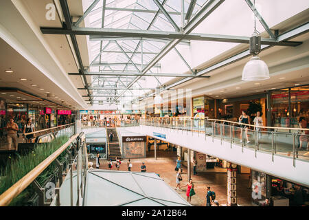 Riga, Latvia - June 9, 2019: People Visiting Origo Shopping Mall. People Going Shopping In Shopping Center Indoor. Stock Photo