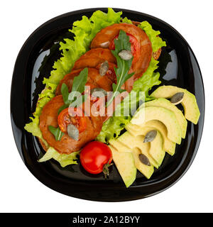 Healthy vegetarian food on a black plate isolated on white. Stock Photo
