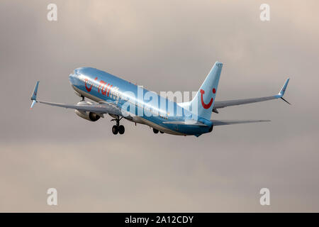 TUIfly Boeing 737-8K5 (REG: D-ATYC) on take off from runway 13 in the morning. Stock Photo