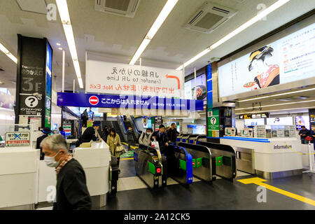 Tokyo, Hamamatsucho station interior. People using the Japanese railway, JR, Transfer gate ticket barrier for the Tokyo Monorail from Haneda airport. Stock Photo