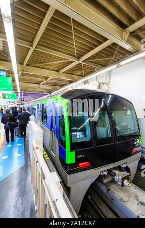 Tokyo Hamamatsucho station interior. Tokyo monorail train at the platform about to depart for Haneda International Airport. People queuing on platform Stock Photo