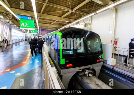 Tokyo Hamamatsucho station interior. Tokyo monorail train at the platform about to depart for Haneda International Airport. People queuing on platform Stock Photo