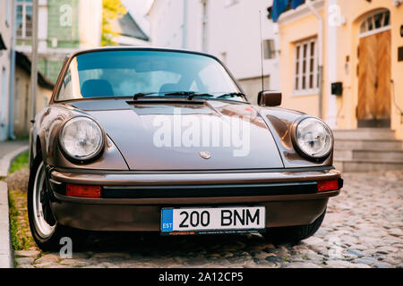 Tallinn, Estonia - July 1, 2019: Front View Of Porsche 930 Car Parked In Old Narrow Street. It is a sports car manufactured by German automobile manuf Stock Photo