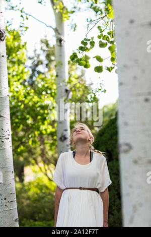 13 year old girl relaxing in aspen tree forest. Stock Photo