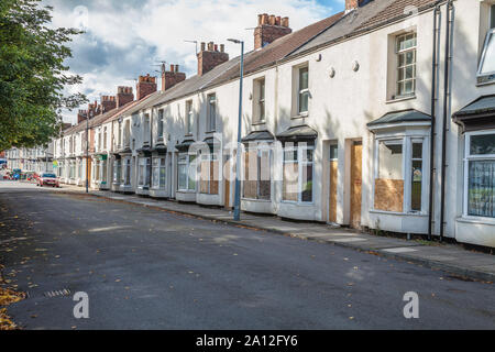 Derelict and boarded up houses in Outram Street, central Middlesbrough,England,UK Stock Photo