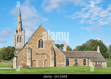 The medieval castle hall at Oakham, Rutland, England, with the spire of All Saints church in the background. Stock Photo