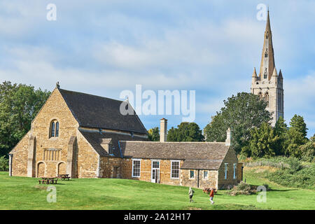 The medieval castle hall at Oakham, Rutland, England, with the spire of All Saints church in the background. Stock Photo