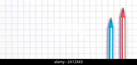 Two striped pencils on white squared paper notebook background. Top view Stock Photo