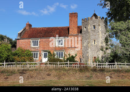 Medieval red brick English House and garden and tower Stock Photo
