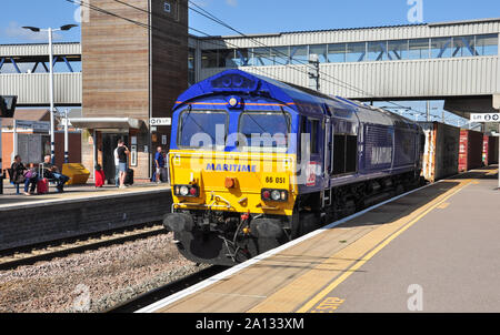 Maritime blue liveried class 66 diesel locomotive hauls a container freight south through Peterborough, Cambridgeshire, England, UK Stock Photo