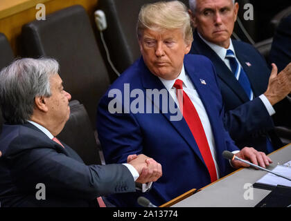 New York, USA,  23 September 2019.  New York City.   US President Donald Trump shakes hands with UN Secretary-General António Guterres (L) as US Vice-President Mike Pence applauds after addressing the  'Global Call to Protect Religious Freedom' event at U.N. headquarters in New York City . Credit: Enrique Shore/Alamy Live News Stock Photo