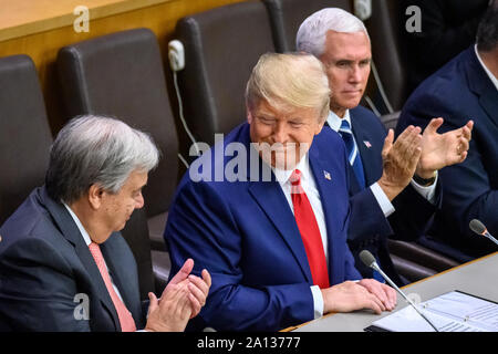 New York, USA,  23 September 2019.  New York City.   US President Donald Trump is applauded by UN Secretary-General António Guterres (L) and US Vice-President Mike Pence applauds after addressing the  'Global Call to Protect Religious Freedom' event at U.N. headquarters in New York City . Credit: Enrique Shore/Alamy Live News Stock Photo