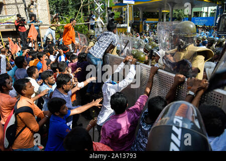 Akhil Bharatiya Vidyarthi Parishad (ABVP) activists try to push through a police barricade as police stop the ABVP's march to Jadavpur University.Akhil Bharatiya Vidyarthi Parishad (ABVP) the right wing students' organisation took out a rally to protest against the September 19 attack on the Union Minister Babul Supriyo in Jadavpur University campus. Stock Photo