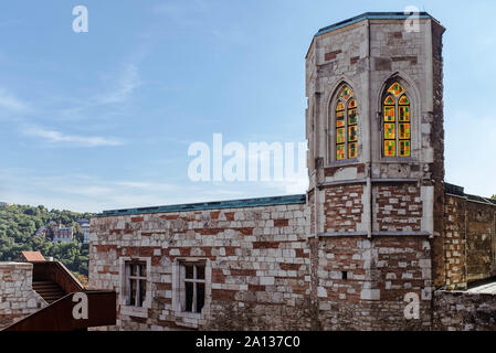 The remains of the Stephen's Tower with colorful stained glass Gothic windows in the Buda Castle. Stock Photo