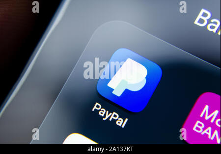 PayPal app seen on the edge of smartphone screen in a group with other banking apps as M&S Bank. Close up photo with shallow depth of field. Stock Photo