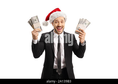 Happy man in a black suit and a Santa Claus hat holding money in both hands isolated on white background Stock Photo