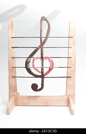 wooden figurine of a treble clef on a stave Stock Photo