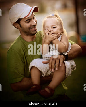 dad holds young daughter Stock Photo